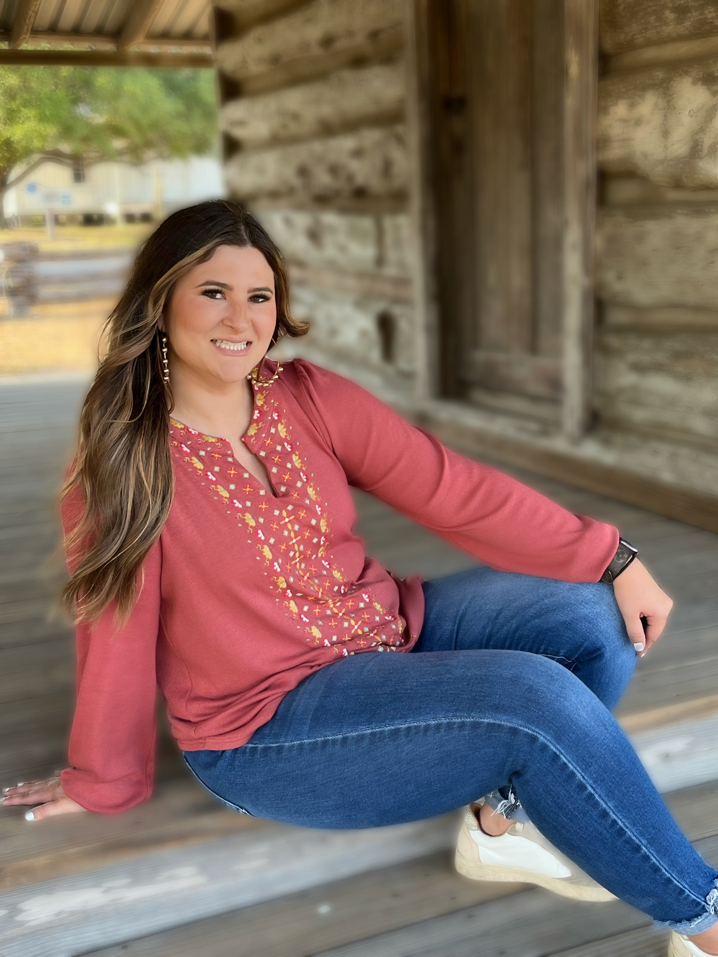 The Charli Top by Washco Apparel includes a notched v-neck with beautiful embroidery design.