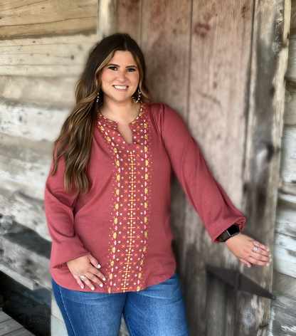 The Charli Top by Washco Apparel includes a notched v-neck with beautiful embroidery design.