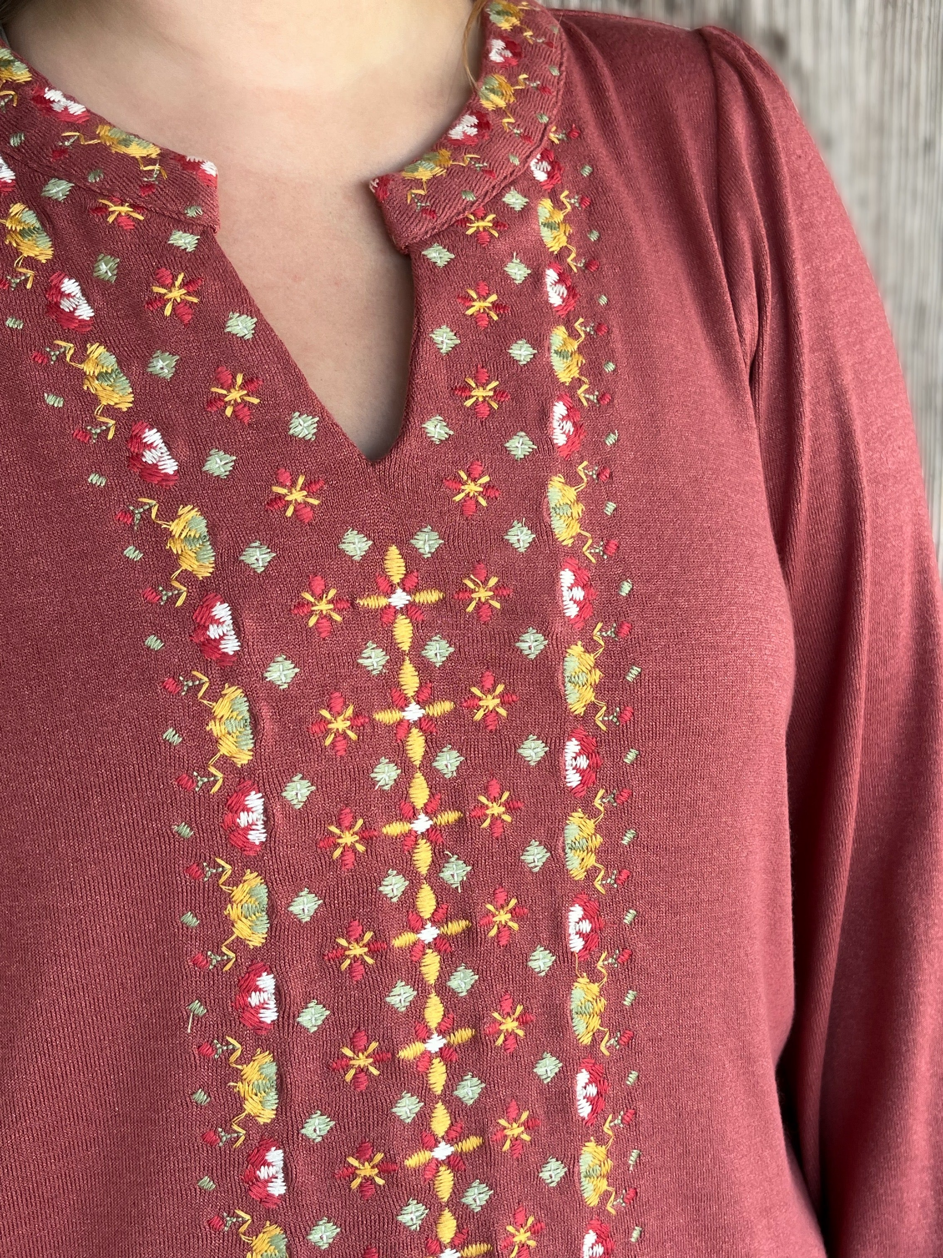 The Charli Top by Washco Apparel includes a notched v-neck with beautiful embroidery design.