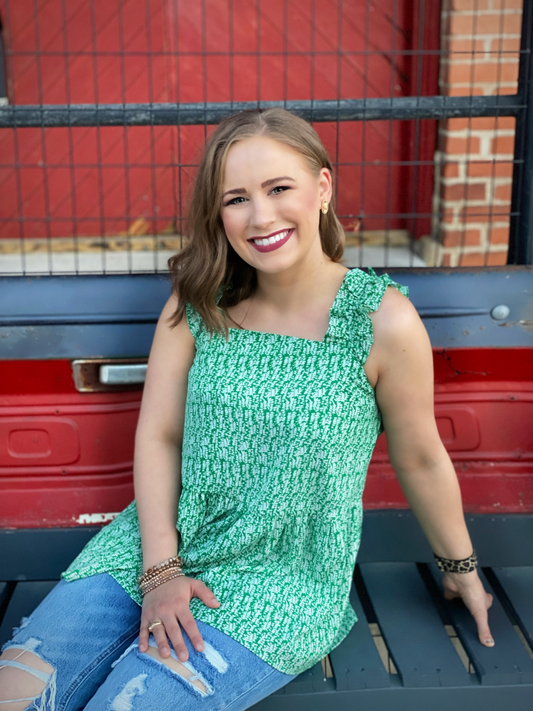 The Chloe Top by Washco Apparel is great top for Spring and Summer! This green and white printed top is fun and flirty with its ruffled sleeves and babydoll fit.