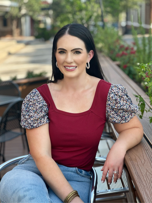 Make a fashion statement with the Abigail top by Washco Apparel! This adorable cropped top has floral sleeves and offers a flattering fit. The top hits right at your high waisted jean line, making it fun and flirty!