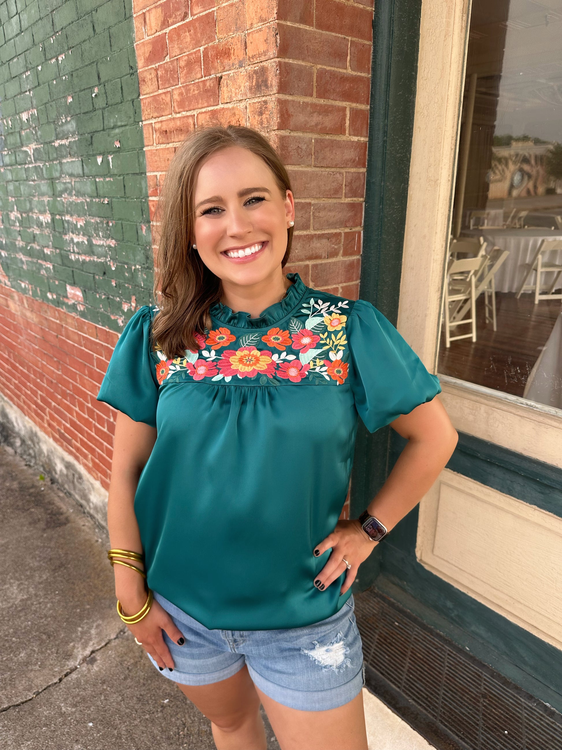 The Amanda top by Washco Apparel is a great top for work and play. The top includes beautiful floral embroidery detail and puffed sleeves.