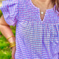 Order Washco Apparel Wholesale - The Annalise Top. Gingham print + smocking detail and ruffled sleeves = perfection! The Annalise top by Washco Apparel is a great top for the Spring and Summer seasons. The top includes beautiful smocking detail and ruffed sleeves with a v-notch neckline.