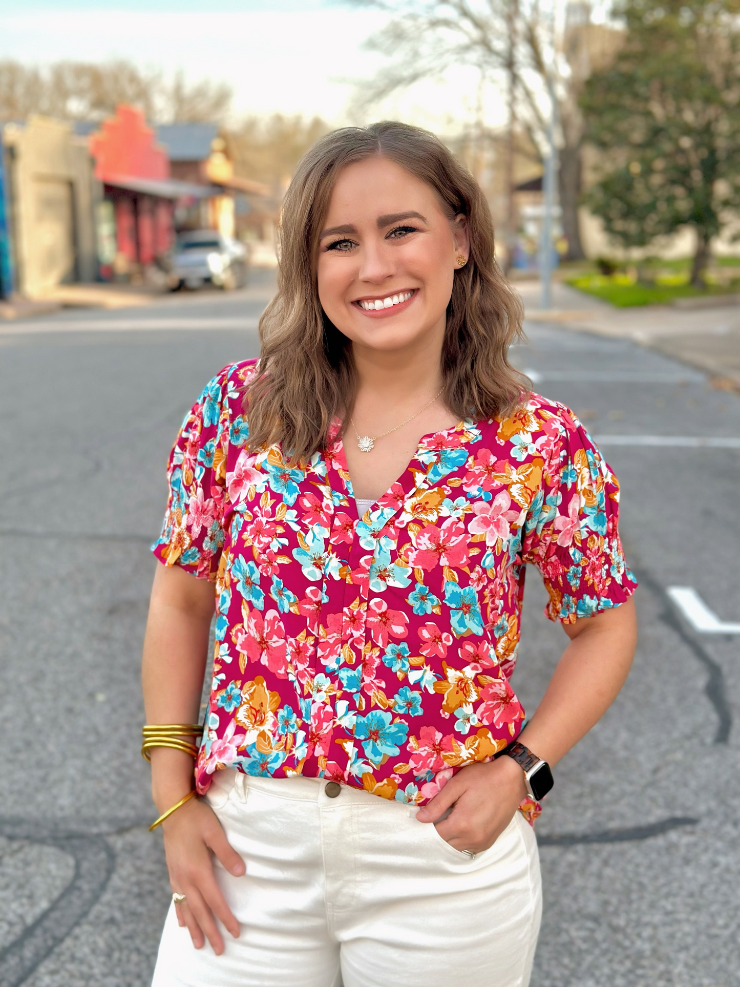 Order Washco Apparel Wholesale - The Connie Top. A print we couldn’t resist! The Connie top by Washco Apparel is a beautiful floral top with short sleeves and smocked detailing around the cuff. This top is great for any occasion!