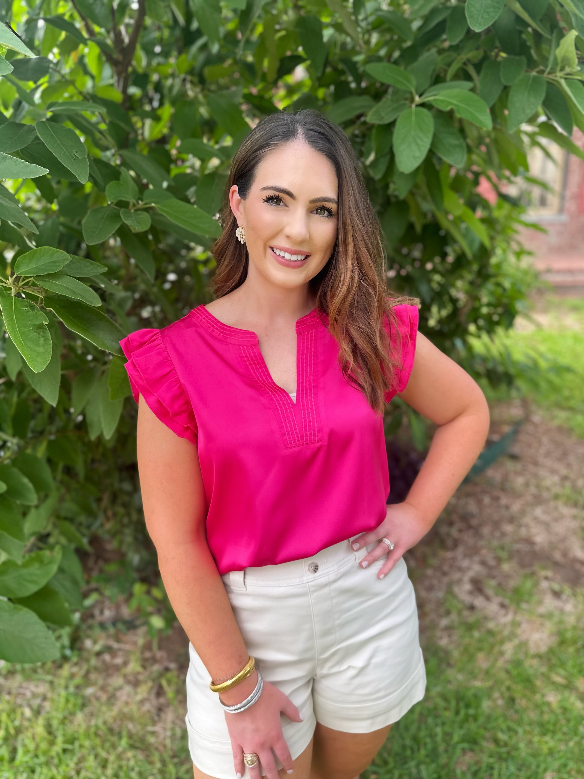 The Miranda top by Washco Apparel is a gorgeous hot pink silky top with ruffle sleeves. This statement top is great for work or play.