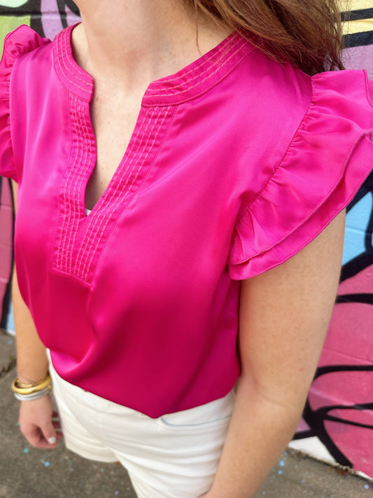 The Miranda top by Washco Apparel is a gorgeous hot pink silky top with ruffle sleeves. This statement top is great for work or play.