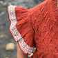 Orange top with smocked and embroidery detailing by Washco Apparel